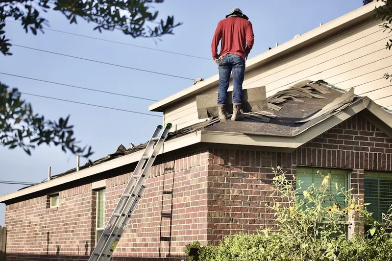 Professional roofer working on a residential roof in Fort Campbell North